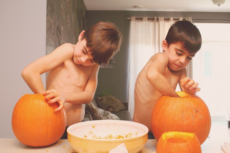 kids carving pumpkins - 70+ Best Family Fall Activities (+ ShredDog Fleece Review)