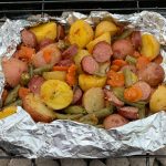 Sausage, fingerling potatoes and veggies foil pack or hobo pies. Garlicky and delicious!