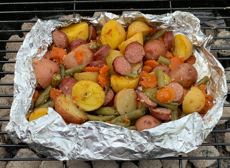 Sausage, fingerling potatoes and veggies foil pack or hobo pies. Garlicky and delicious!