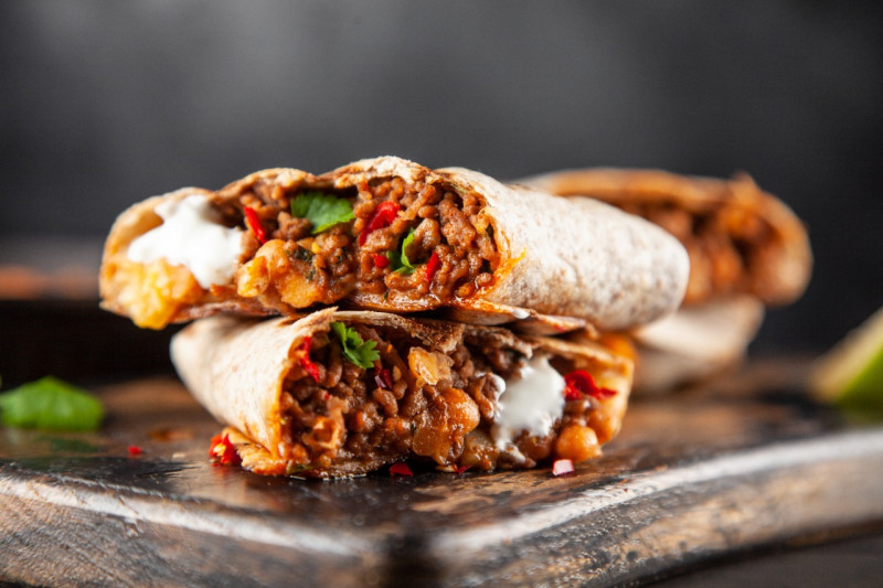 Two cut open burritos on a table