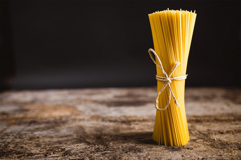 Raw spaghetti on wooden table