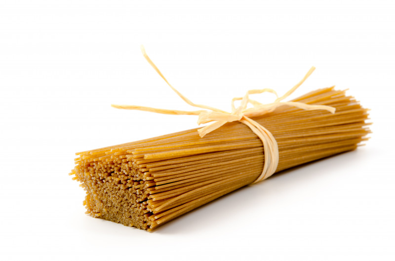 Raw spaghetti with white twin on white background