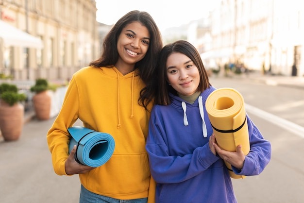 best-friends-holding-fitness-mat