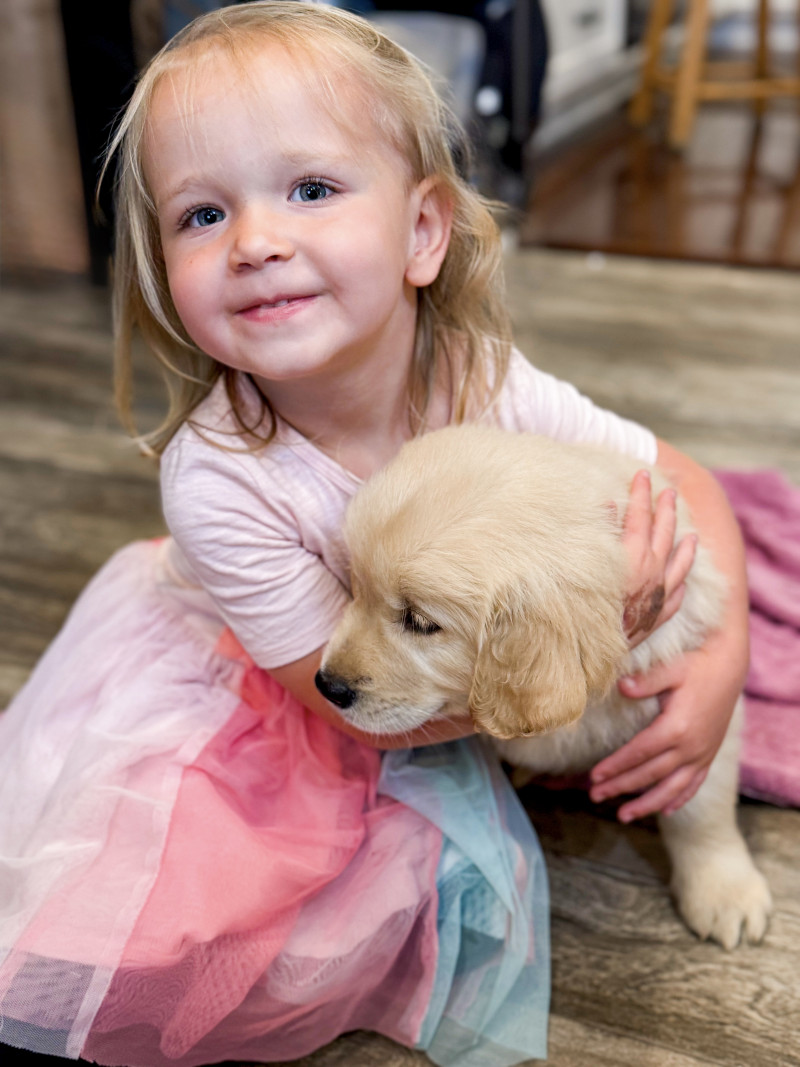 Girl with puppy. Minnesota Summers For Our Farm Family.