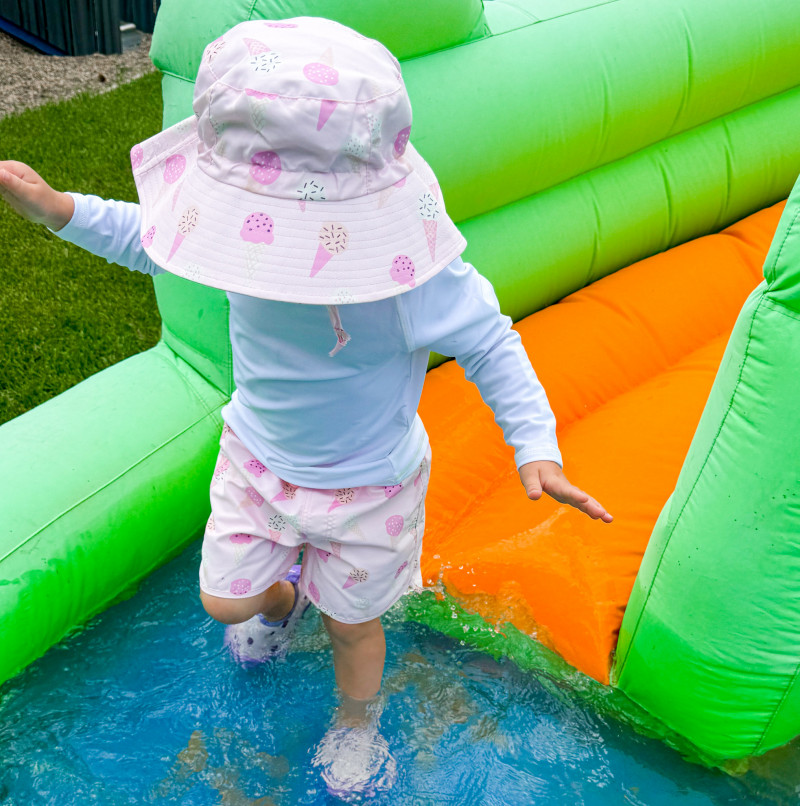 Girl splashing in water. Minnesota Summers For Our Farm Family.