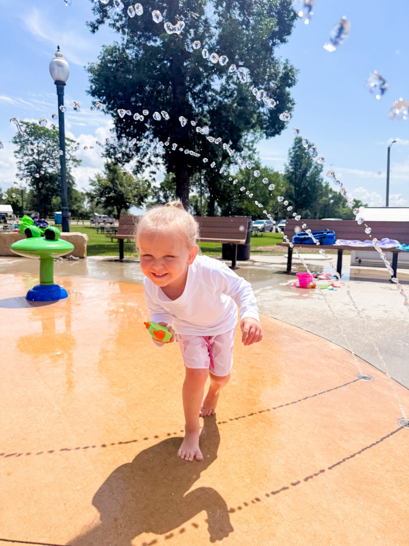 Little girl at a splash pad.