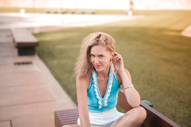 Woman wearing a halter top in a casual summer outfit at a park
